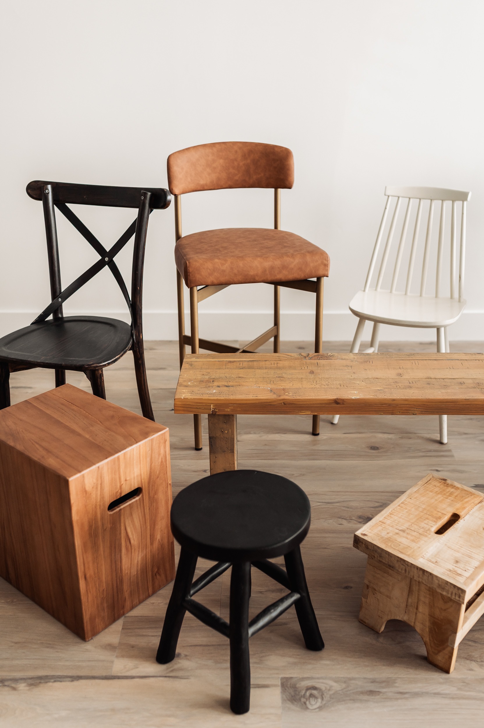 Seating props available at The Loft Studio Ottawa photography studio including wooden stools, benches, and neutral-toned chairs