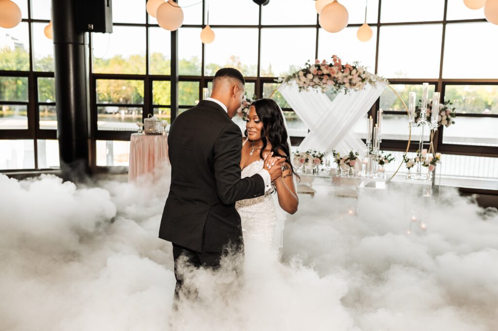 Wedding reception first dance with fog effect inside Lago wedding venue overlooking Dow’s Lake in Ottawa