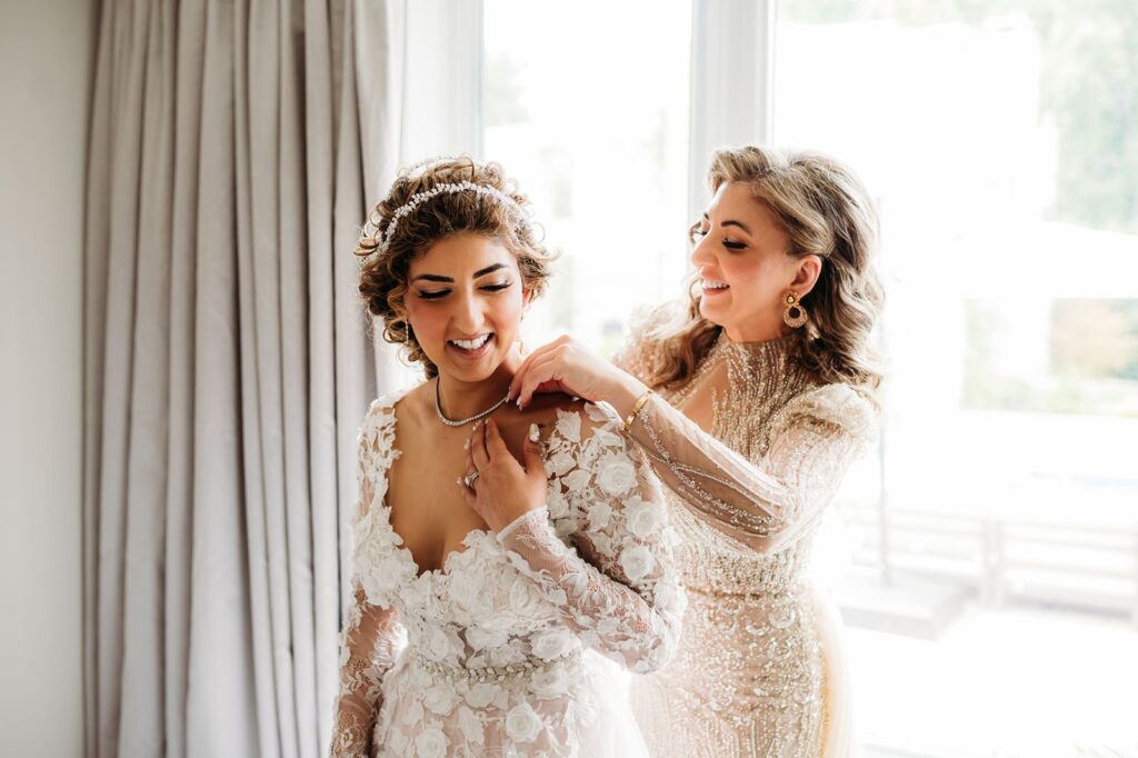 Bride getting ready with help from mother during the morning of her Ottawa wedding day
