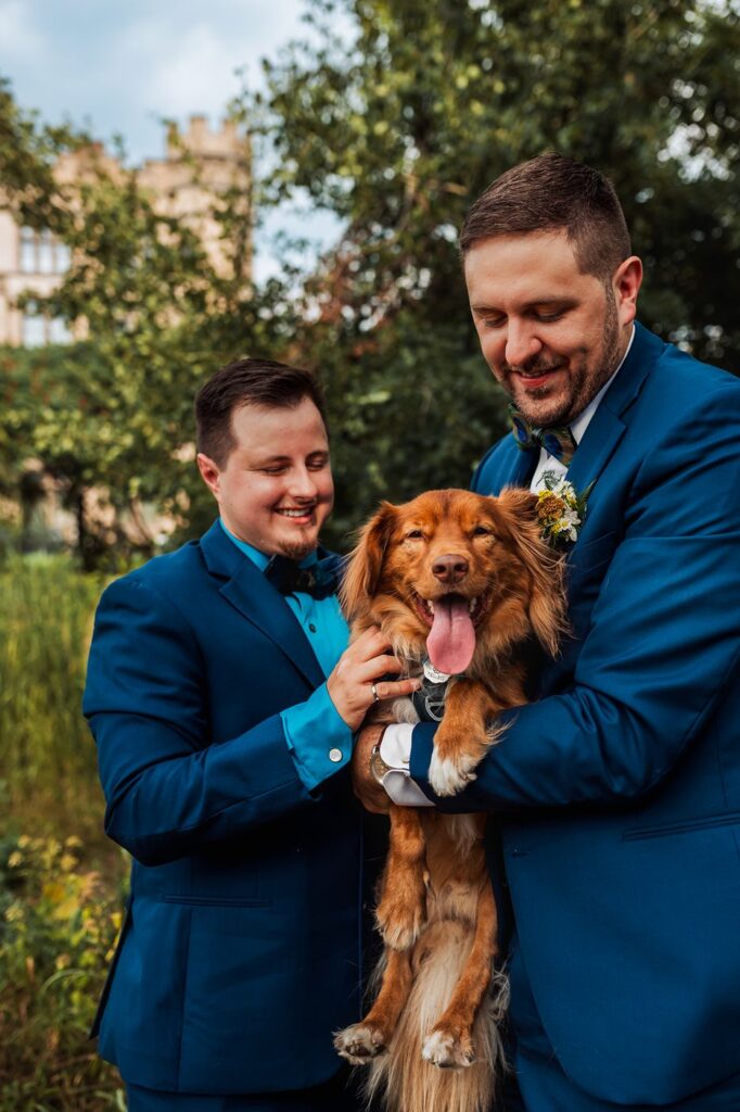 Couple holding their dog Darwin during portraits at the Canadian Museum of Nature