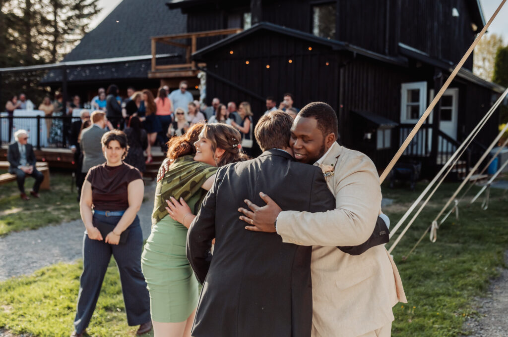 bride and groom hugging the guests
